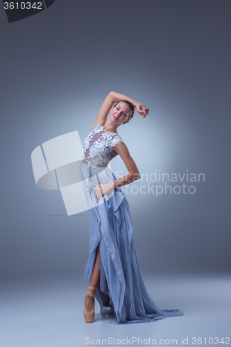 Image of The beautiful ballerina dancing in blue long dress 