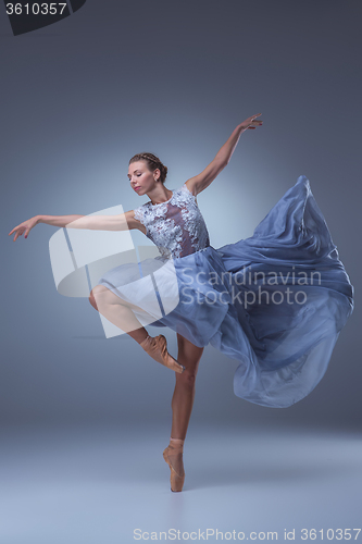Image of The beautiful ballerina dancing in blue long dress 
