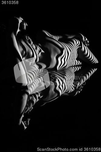 Image of The nude woman with black and white zebra stripes