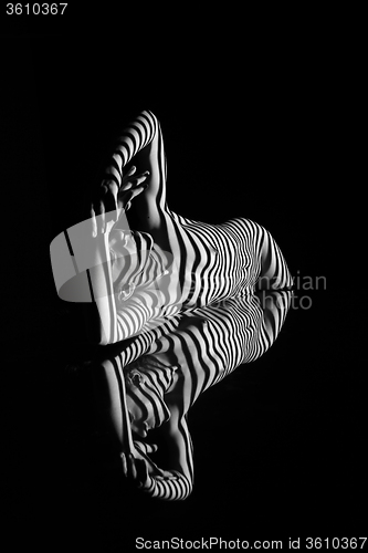 Image of The nude woman with black and white zebra stripes