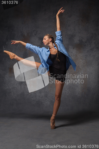 Image of Young beautiful modern style dancer posing on a studio background