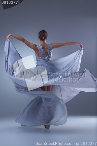 Image of The beautiful ballerina dancing in blue long dress 