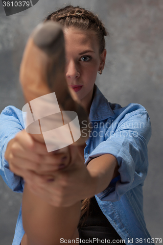 Image of Young beautiful modern style dancer posing on a studio background