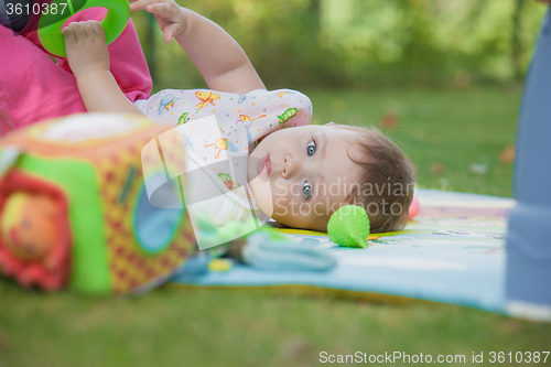 Image of Baby, less than a year old   playing with  toy 