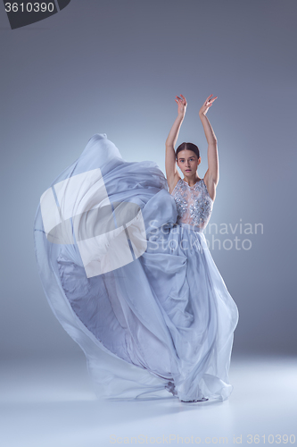 Image of The beautiful ballerina dancing in blue long dress 