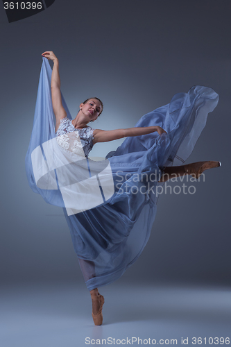 Image of The beautiful ballerina dancing in blue long dress 