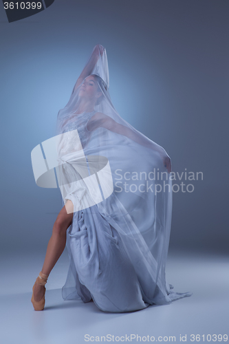 Image of The beautiful ballerina dancing in blue long dress 