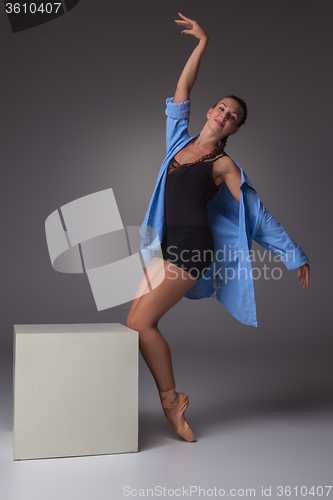 Image of Young beautiful modern style dancer posing on a studio background