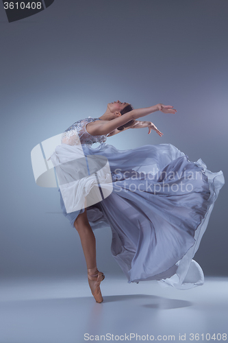 Image of The beautiful ballerina dancing in blue long dress 