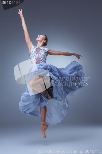 Image of The beautiful ballerina dancing in blue long dress 