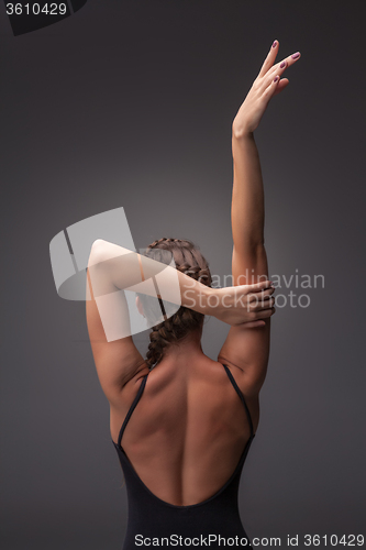 Image of Young beautiful modern style dancer posing on a studio background