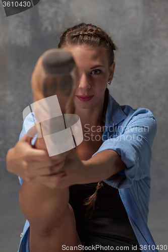 Image of Young beautiful modern style dancer posing on a studio background