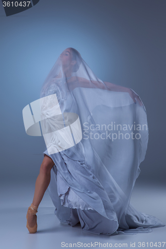 Image of The beautiful ballerina dancing in blue long dress 