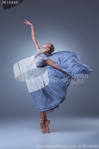 Image of The beautiful ballerina dancing in blue long dress 