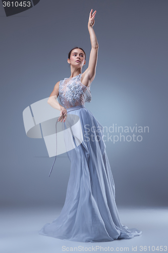 Image of The beautiful ballerina dancing in blue long dress 