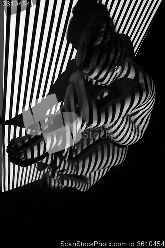 Image of The nude woman with black and white zebra stripes