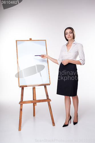 Image of young business woman showing something on the white background