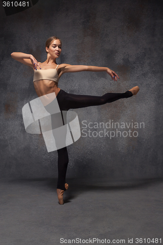 Image of Young beautiful modern style dancer posing on a studio background