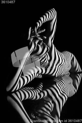 Image of The nude woman with black and white zebra stripes