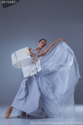 Image of The beautiful ballerina dancing in blue long dress 