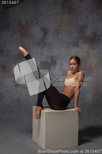 Image of Young beautiful modern style dancer posing on a studio background