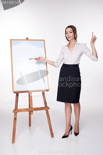 Image of young business woman showing something on the white background