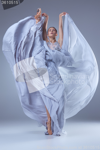 Image of The beautiful ballerina dancing in blue long dress 