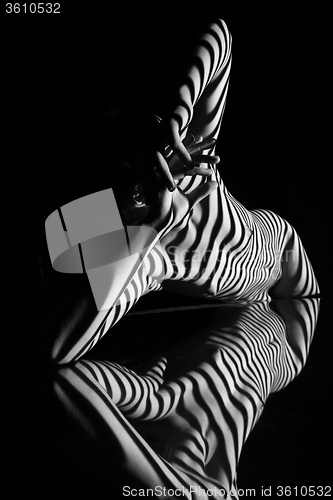 Image of The nude woman with black and white zebra stripes