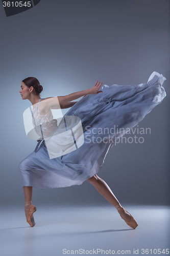 Image of The beautiful ballerina dancing in blue long dress 