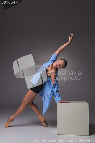 Image of Young beautiful modern style dancer posing on a studio background