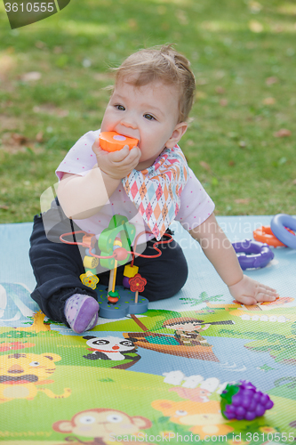 Image of Baby, less than a year old   playing with  toy 