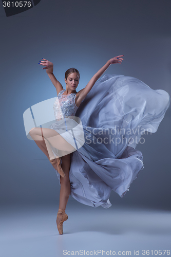 Image of The beautiful ballerina dancing in blue long dress 