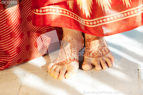 Image of Legs decorated with indian mehandi painted henna close up