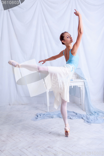 Image of Professional ballet dancer posing on white
