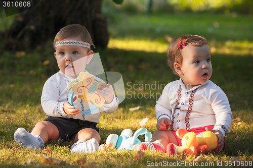 Image of Babys, less than a year old, playing with  toys 