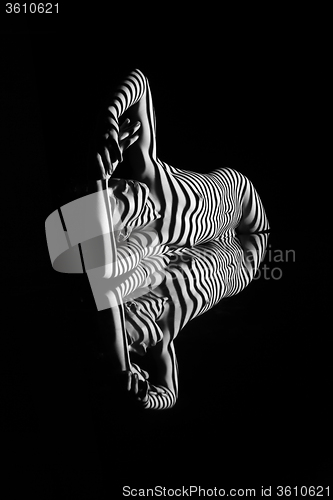 Image of The nude woman with black and white zebra stripes