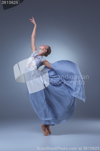 Image of The beautiful ballerina dancing in blue long dress 