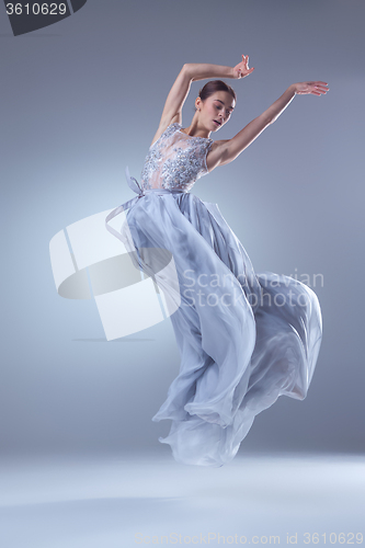 Image of The beautiful ballerina dancing in blue long dress 