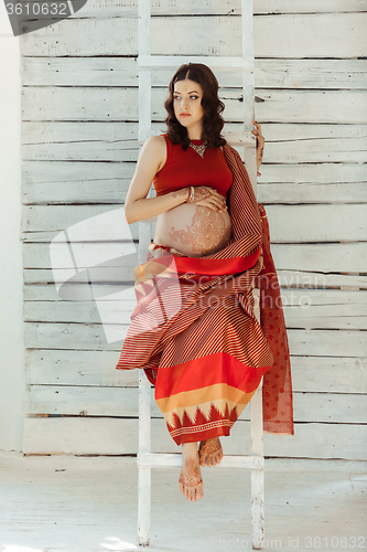 Image of Indian picture on woman decorated with indian mehandi painted henna 