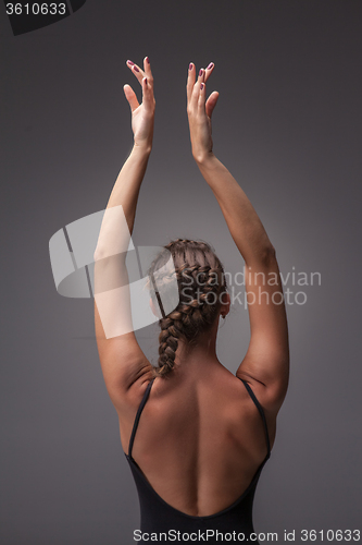 Image of Young beautiful modern style dancer posing on a studio background