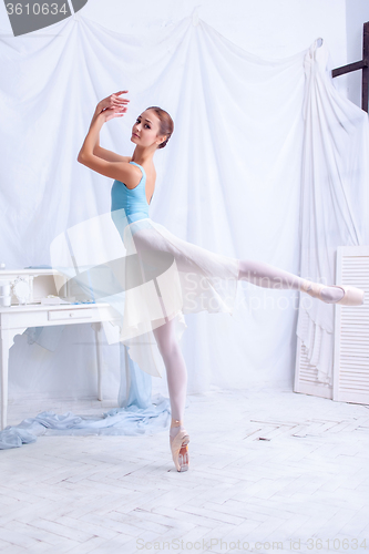 Image of Professional ballet dancer posing on white