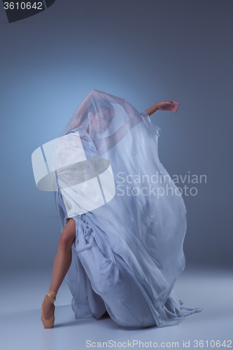 Image of The beautiful ballerina dancing in blue long dress 