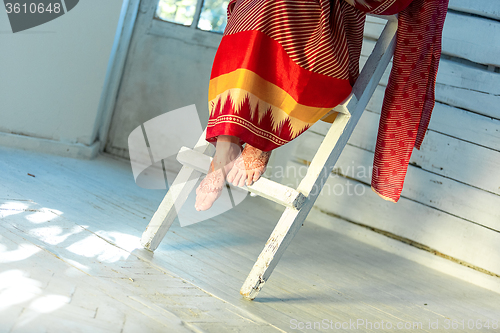 Image of Legs decorated with indian mehandi painted henna 