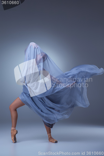 Image of The beautiful ballerina dancing in blue long dress 