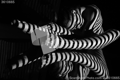 Image of The nude woman with black and white zebra stripes