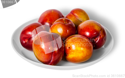 Image of Red and yellow plums on white plate
