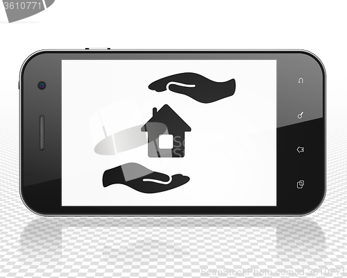 Image of Insurance concept: Smartphone with House And Palm on display