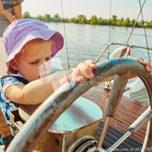 Image of Little girl enjoying ride on yacht