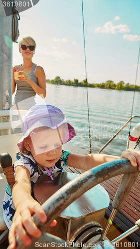 Image of Little girl enjoying ride on yacht