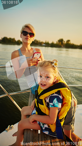 Image of Mother, daughter on yacht.  Concept of the family